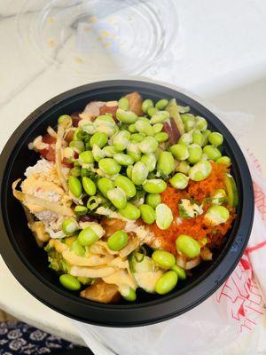 Salmon and tuna poke bowl with brown rice, edamame, masago, crab and spicy Mayo