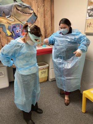 JABSOM student suits up to see a patient at the car with Dr Chan