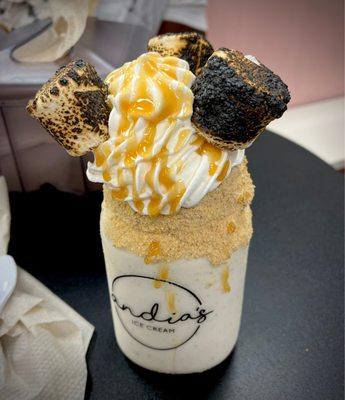 Torched S'more vanilla milk shake with caramel dripped on top.