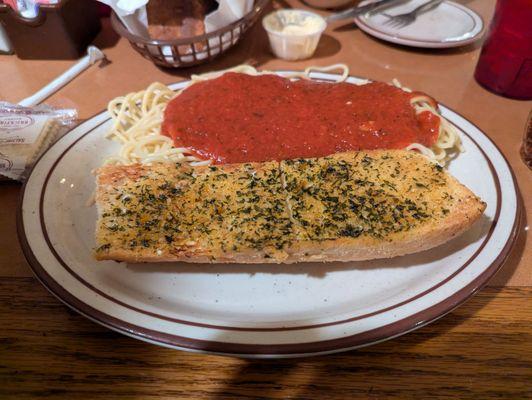 Spaghetti with marinara sauce and a giant slab of garlic bread!