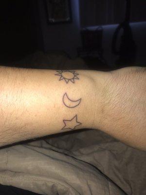 Simple sun moon and star on upper wrist. I know it was a real easy one for him, but exactly how I wanted it