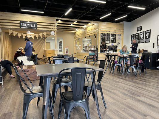 A view from a small table on the left of the entrance looking in. The study hall in on the back left and the counter on the back right.