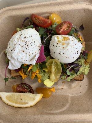 Avocado Sourdough toast w poached eggs. The yummy field of greens are beautiful & tasty!