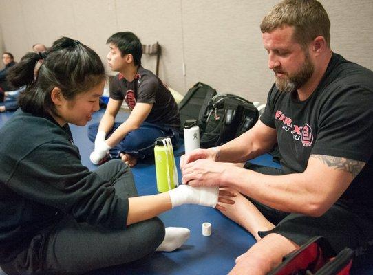 Coach Matt wrapping hands before a fight.