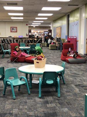 The main area for kids to explore books on comfy couches and play in their dramatic area.