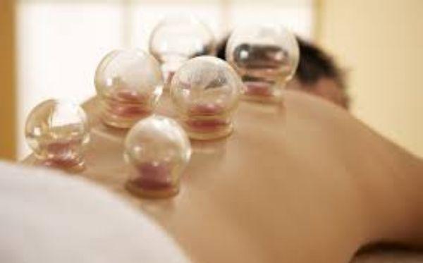 Picture of glass cupping on a person's back while laying face down