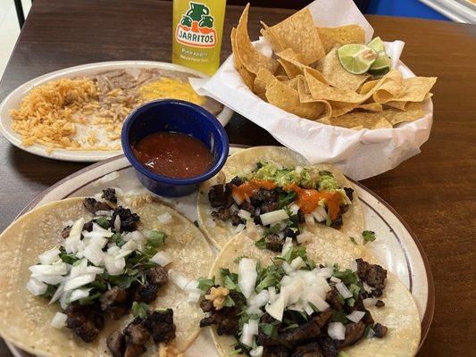 Carne asada tacos (grilled steak) street tacos with side of rice & beans. Salsa & chips