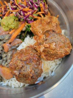 Meatball Rice bowl: 3 juicy all beef scratch made meatballs over rice and steamed kale. Pictured with a side of lentils and rainbow slaw