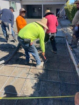 Workers pouring concrete.