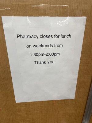 The haphazard changing of lunch paper taped to the wall near the front of the pharmacy.