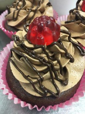 Gluten Free Chocolate Raspberry Filled with Chocolate Buttercream drizzled with dark chocolate and topped with a raspberry gummy