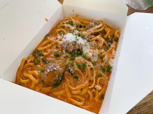 Linguine with pink sauce, spinach, garlic, and meatballs