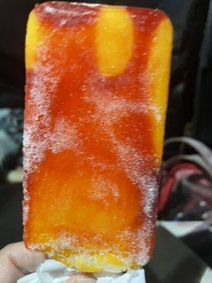 Mango popsicle with frost burn . It's been on that freezer for awhile !