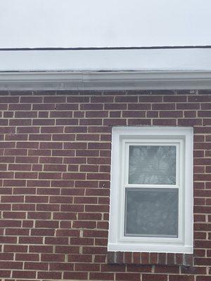 Above Window to the left where two gutters meet (leaks)