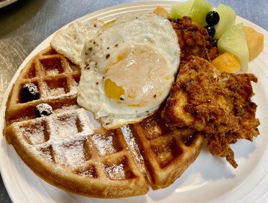 Fried chicken and waffles with fried eggs. Enjoy it with real grade A maple syrup.