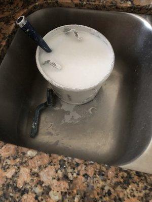 Left paint bucket in kitchen sink and left