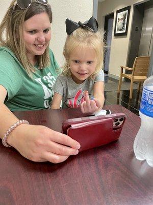 Showing off her multicolored nails on FaceTime!