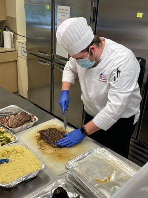 Chef Jonathan Barger of JACK Casino making steak dinners for families at RMHC NEO