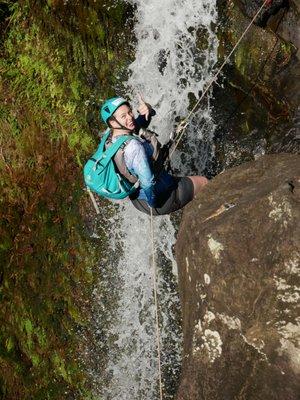 Trinity rappelling in waterfall