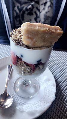 Greek yogurt parfait with almond brittle, Granola, and fresh seasonal berries.