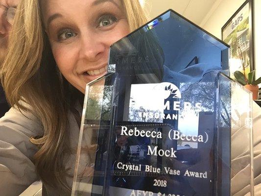 Becca with her Crystal Blue Vase Award for Life Insurance