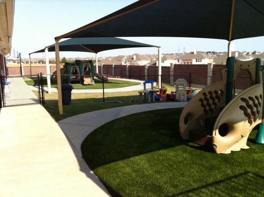 1 of 4 Age-Appropriate Playgrounds with turf and shade covers.