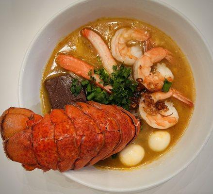 Bánh Canh Cua. 
Homemade thick rice noodles soup served with crab and shrimp. Add lobster tail