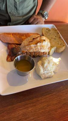 Two lobster tails with sides and a great piece of salmon.