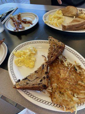 Scrambled eggs, hashbrowns, toast, bacon