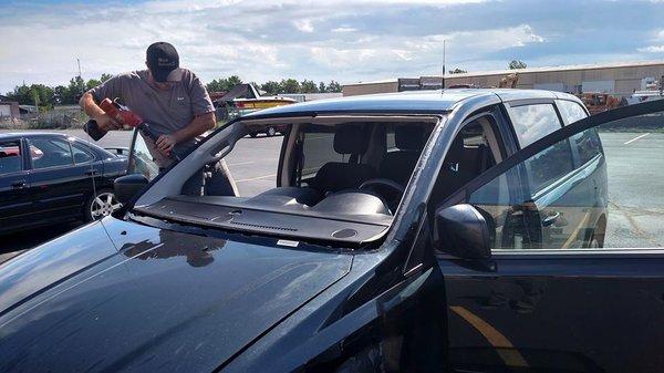 Employee repairing auto glass