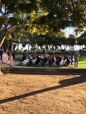 Beautiful view of an ocean-side wedding ceremony from our outdoor bar setup.