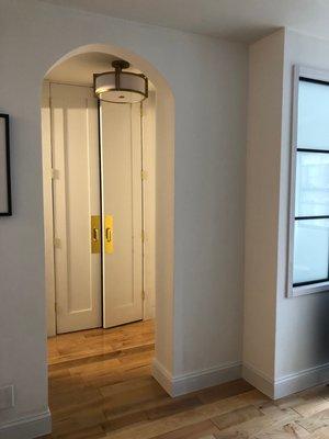 Custom floor to ceiling closet doors, and new arched opening. Elegant and really elevates the space!