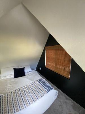 View of loft bed and window.