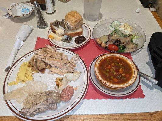 Buttered noodles, turkey/dressing w gravy, cod, ham ball, pork & sauerkraut, cabbage, bread, salad w hot bacon dressing, beef veggie soup