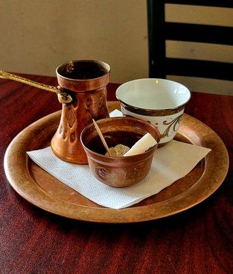 Turkish Coffee. It's unfiltered meant to be sipped. It's served with hard sugar and some jelly candy.