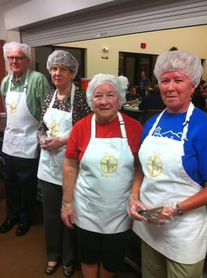 Members of St Anthony on the Desert serving a meal at EVMC.