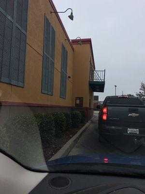 The drive thru this location puts the hand up outside the drive thru window to have you stop before  the pick up window