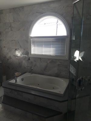 Architect put a window by the tub? Call Budget Blinds for a faux wood blind - we can even make them voice controlled tilt.