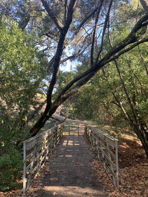 Bridge at the end and loops back to parking lot on the left