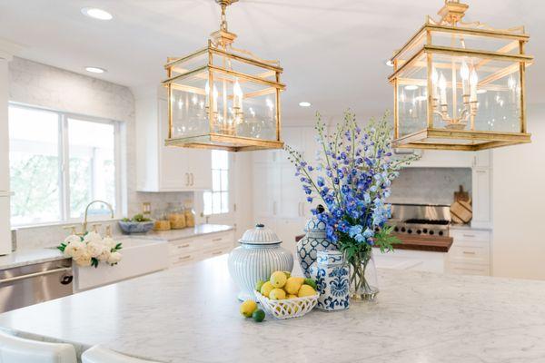 Square pendant lights add a beautiful focal point to this classic white kitchen.