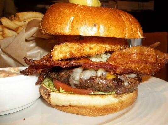 close-up of prime burger w/applewood bacon, onion ring