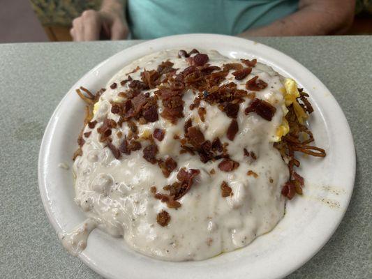 Special - on the menu... Biscuit smothered with eggs, cheese, crispy hash browns and covered with the best sausage gravy I have ever had...