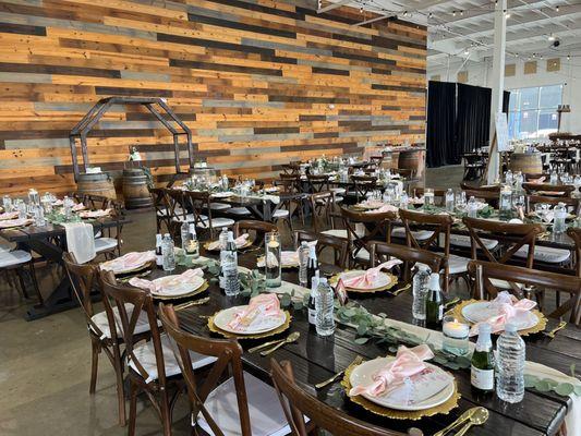 Beautiful wall made out of wood and farm tables create a rustic and elegant environment.