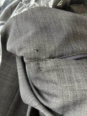 Hole in suit pants below zipper before repairing