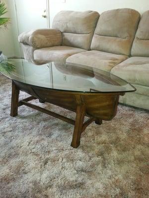 Coffee table shaped like a boat.