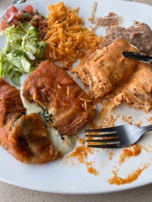 Half eaten Chile relleno & half eaten enchilada with chipotle cream sauce