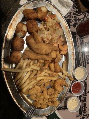 Catfish, boiled shrimp, fried shrimp, crab meat, fries and hushpuppies