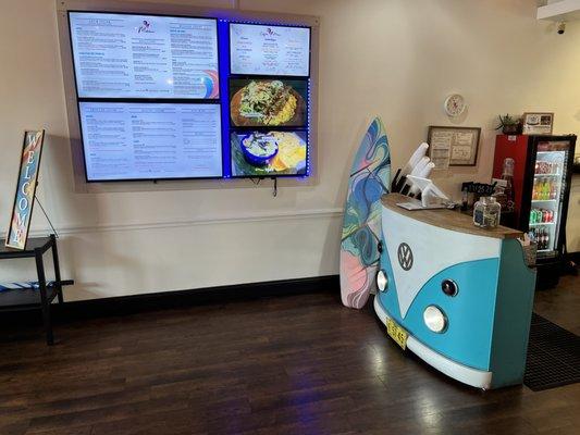 Super cute ordering station with digital menu on the wall.