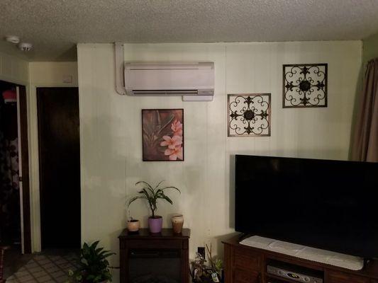 Daikin indoor unit, mounted on interior wall. With a condensate pump mounted below unit.