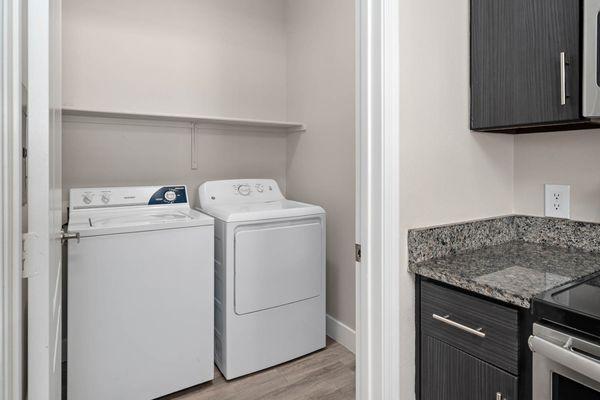 The Met interior laundry room with washer and dryer